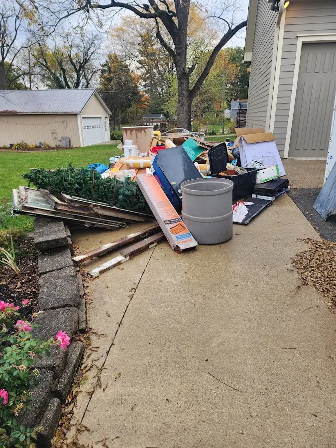 Dumpster being loaded with debris for 30 Yard Dumpster Rental in Lawrence
